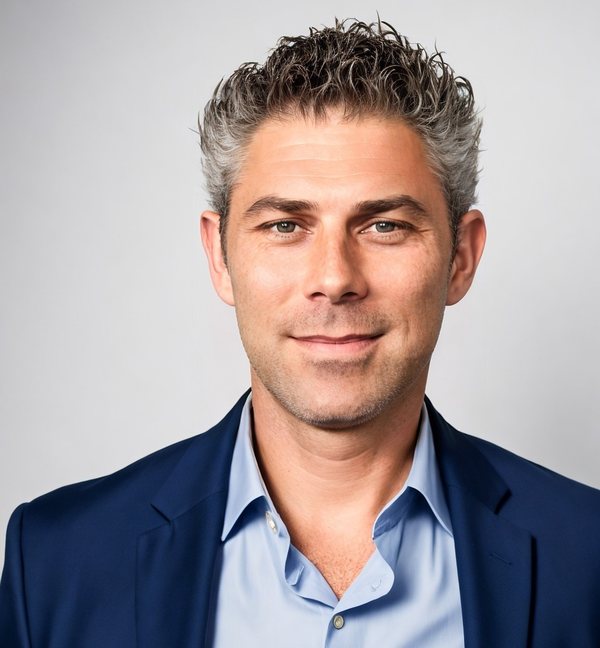 Matt Thompson, owner of Construction Corps, in a navy blazer and light blue shirt